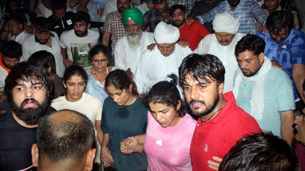 Protesting wrestlers Sakshi Malik, Vinesh Phogat and Sangeeta Phogat at Har ki Pauri ghat, in Haridwar, Tuesday, May 30, 2023. Credit: PTI Photo