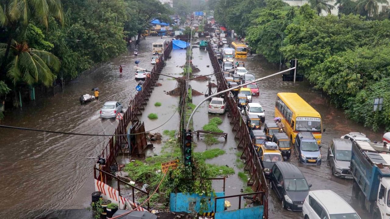 Vehicles stuck in a traffic jam on a waterlogged road following Monsoon rains, in Mumbai. Credit: PTI Photo