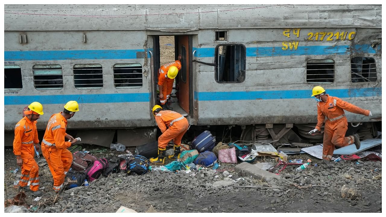 NDRF personnel during the restoration work at the site of Friday's triple train accident near Bahanaga Bazar railway station, in Balasore district. Credit; PTI Photo