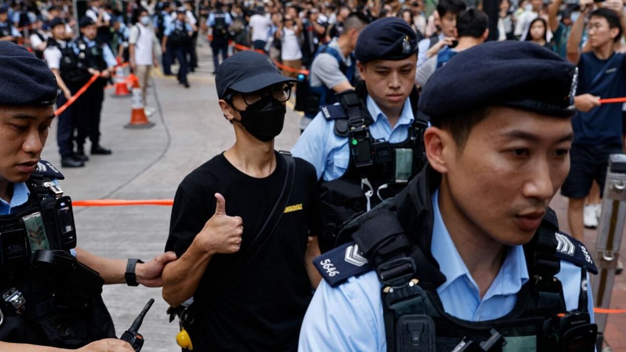 Police detain a man in downtown on the 34th anniversary of the 1989 Beijing's Tiananmen Square crackdown, near where the candlelight vigil is usually held, in Hong Kong. Credit: Reuters Photo