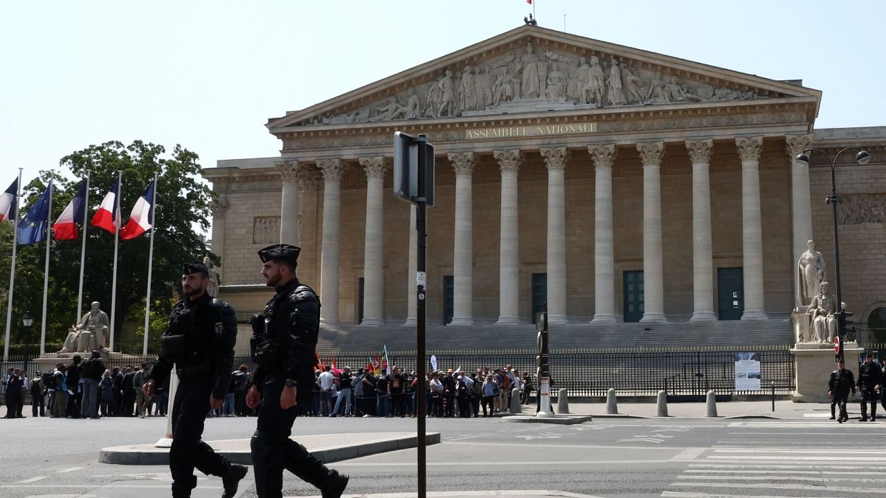 French gendarmes walk past the National Assembly during a press conference by heads of French labour unions before a demonstration in Paris as part of the 14th day of nationwide protests against French government's pension reform law, France, June 6, 2023. Credit: Reuters Photo