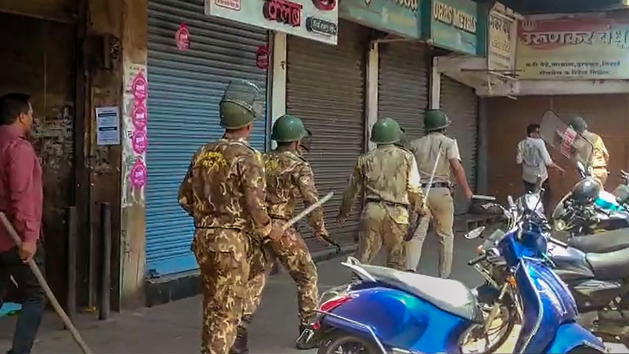 Security personnel attempt to disperse agitators objecting to the alleged use of Tipu Sultan’s image along with an objectionable audio message as social media 'status' by some locals, in Kolhapur district. Credit: PTI Photo