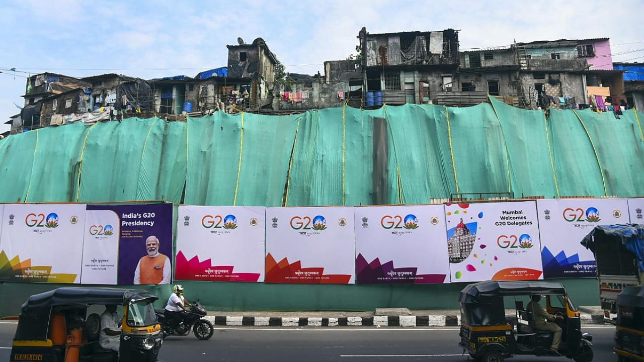 Green curtains put up outside Jogeshwari slums along the Western Express Highway as the city is hosting several G20 meetings, in Mumbai. Credit: PTI Photo