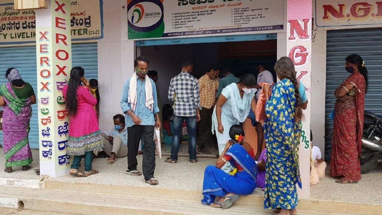 People at Seva Sindhu Seva Kendra in Chamarajanagar Municipal Council office building on Friday. Credit: DH Photo