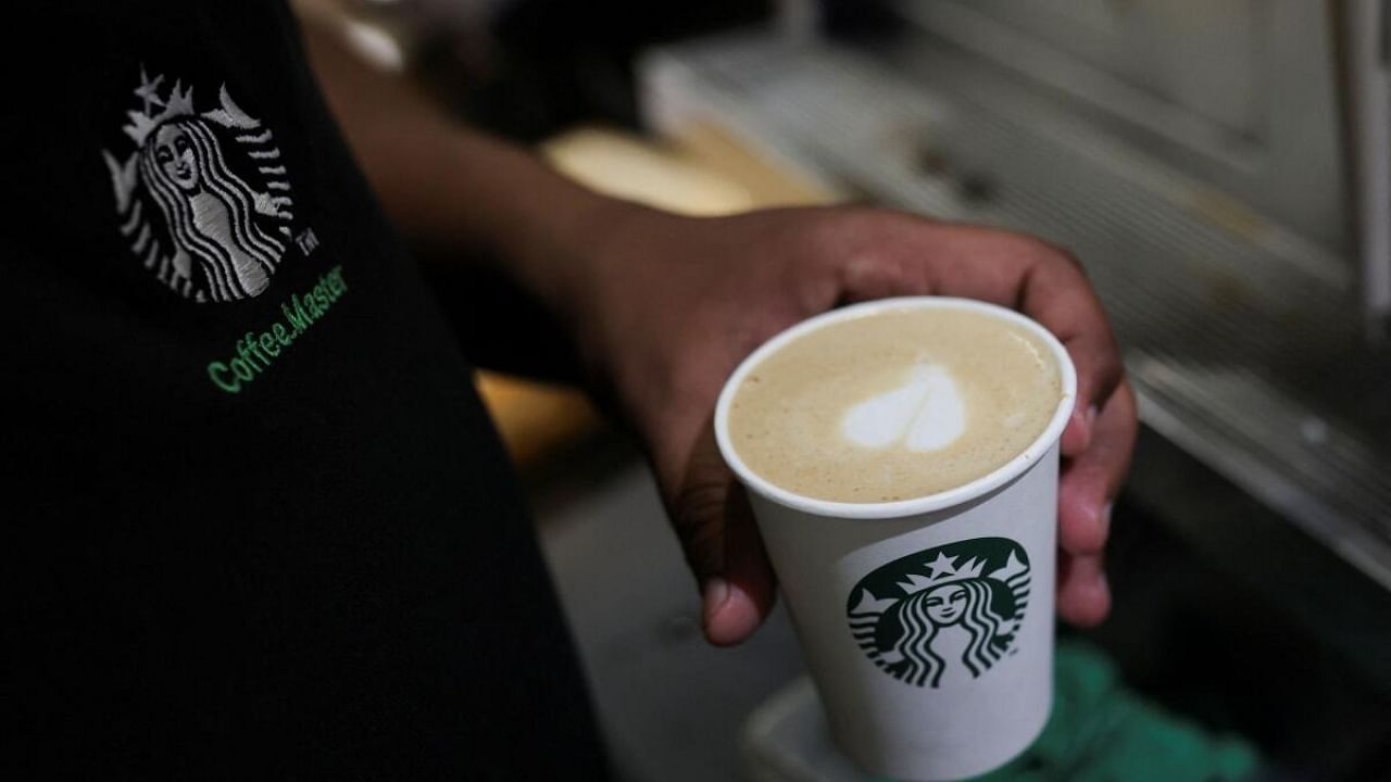 An employee prepares a coffee drink at a Starbucks' outlet at a market in New Delhi, India, May 30, 2023. Credit: Reuters Photo