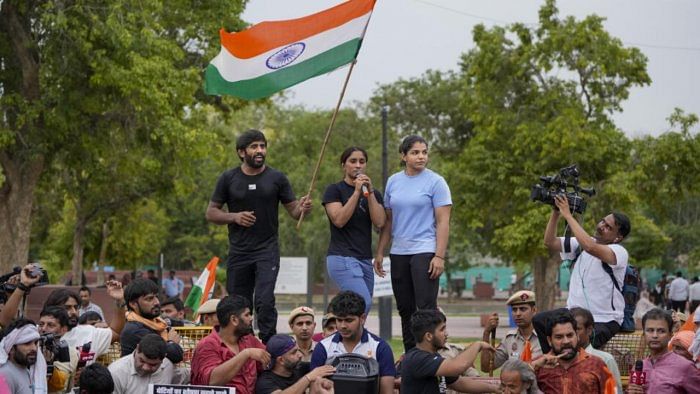Wrestlers Vinesh Phogat, Sakshi Malik and Bajrang Punia with supporters during their candlelight protest march, at India Gate in New Delhi, Tuesday, May 23, 2023. Credit: PTI Photo