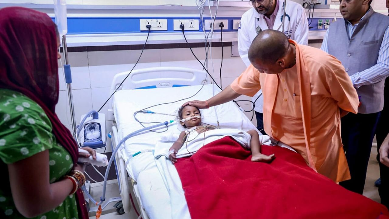 Uttar Pradesh Chief Minister Yogi Adityanath meets the girl who was injured in the shootout on Lucknow Court premises on Wednesday, at King George's Medical University (KGMU) in Lucknow. Credit: IANS Photo