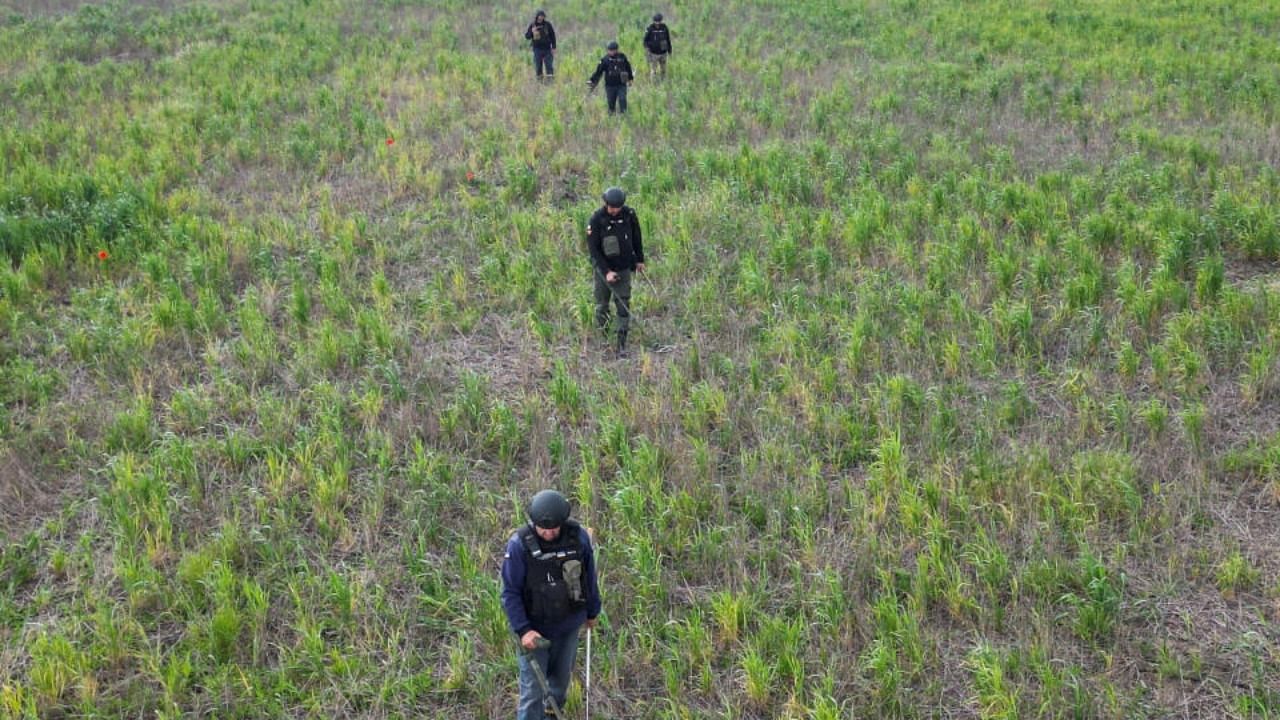 Members of the State of Emergency Service inspect for mines and unexploded shells near Blahodatne in Mykolaiv. Credit: Reuters Photo