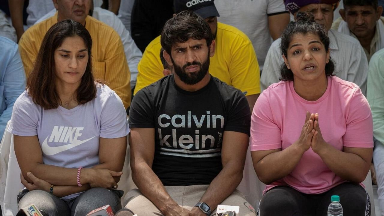 Wrestlers Vinesh Phogat, Bajrang Punia, and Sakshi Malik address a news conference as they take part in a sit-in protest demanding arrest of Wrestling Federation of India (WFI) chief, who they accuse of sexually harassing female players, in New Delhi, India, April 24, 2023. Credit: Reuters File Photo