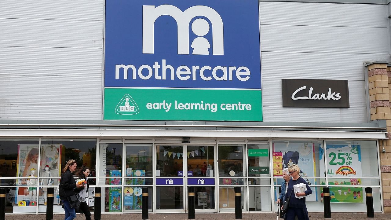  People walk past a Mothercare store in Altricham, Britain. Credit: Reuters Photo
