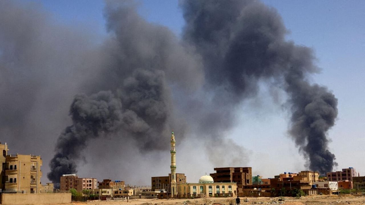 Smoke rises above buildings after aerial bombardment, during clashes between the paramilitary Rapid Support Forces and the army in Khartoum North, Sudan. Credit: Reuters Photo