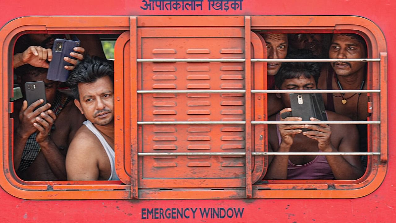 Passengers inside the Coromandel Express train as it leaves from Bahanaga Bazar railway station after train services resumed. Credit: PTI Photo