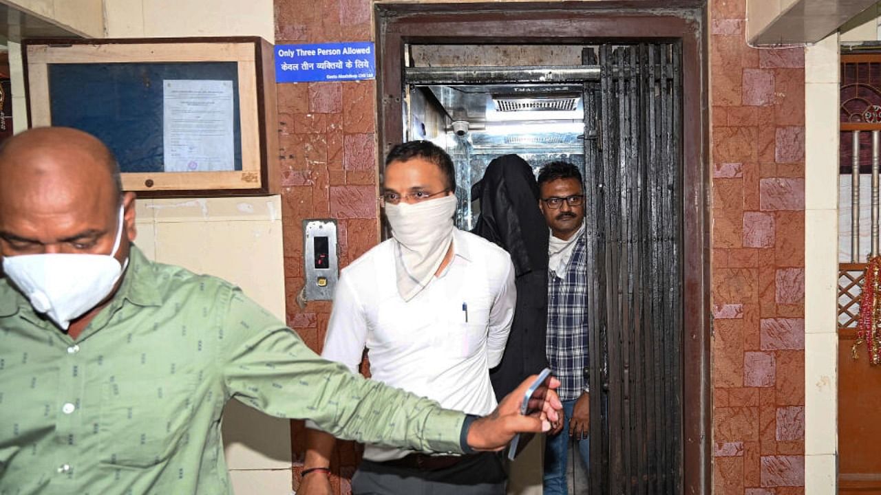 Police personnel take 56-year-old accused Manoj Sane into custody. Credit: PTI Photo