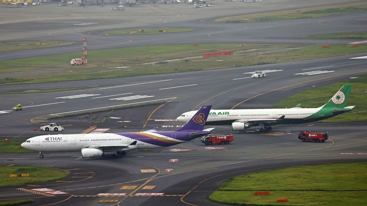 An aerial view shows Thai Airways and Eva Air aeroplanes on a taxiway after making contact at Haneda Airport, in Tokyo, Japan. Credit: Reuters Photo