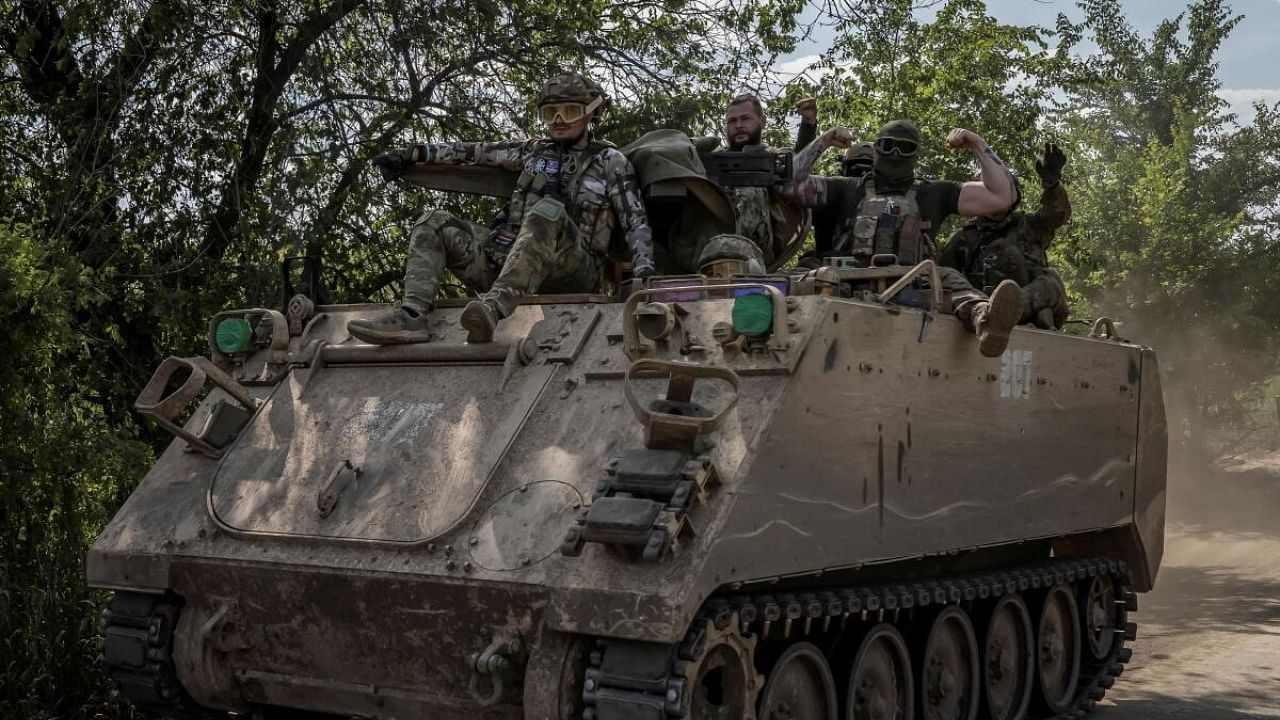 Ukrainian service members ride a M113 armoured personnel carrier, amid Russia's attack on Ukraine, near the front line city of Bakhmut, Donetsk region. Credit: Reuters Photo