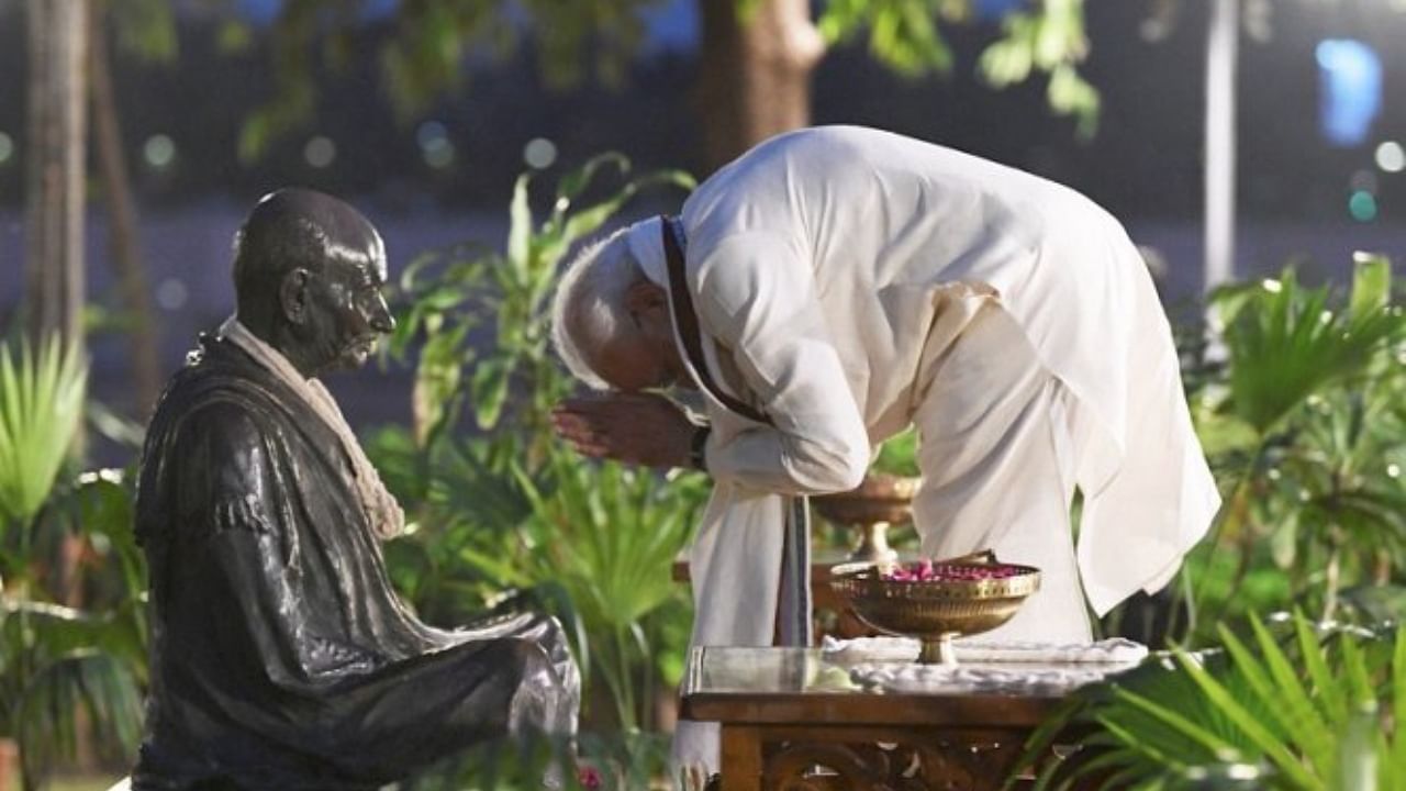 Prime Minister Narendra Modi pays homage to Mahatma Gandhi, on his 150th birth anniversary, at Sabarmati Ashram in Ahmedabad. Credit: PTI Photo