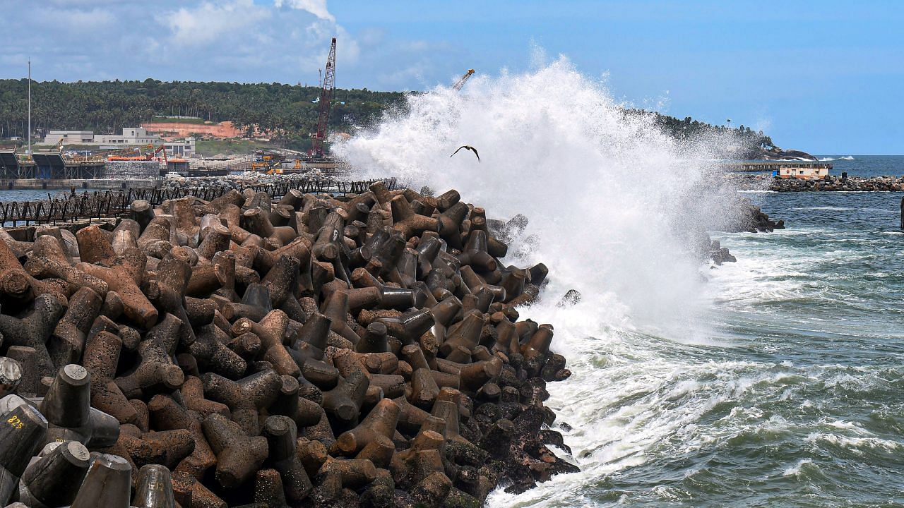 High tidal waves crash on the shore at the Vizhinjam harbour in Thiruvananthapuram. Credit: PTI Photo