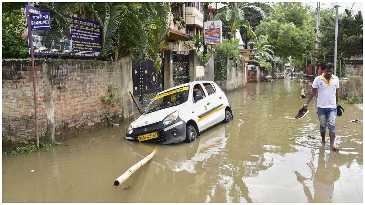 A car remains stuck on a waterlogged street of Hatigoan area after rain, in Guwahati. Credit: PTI Photo