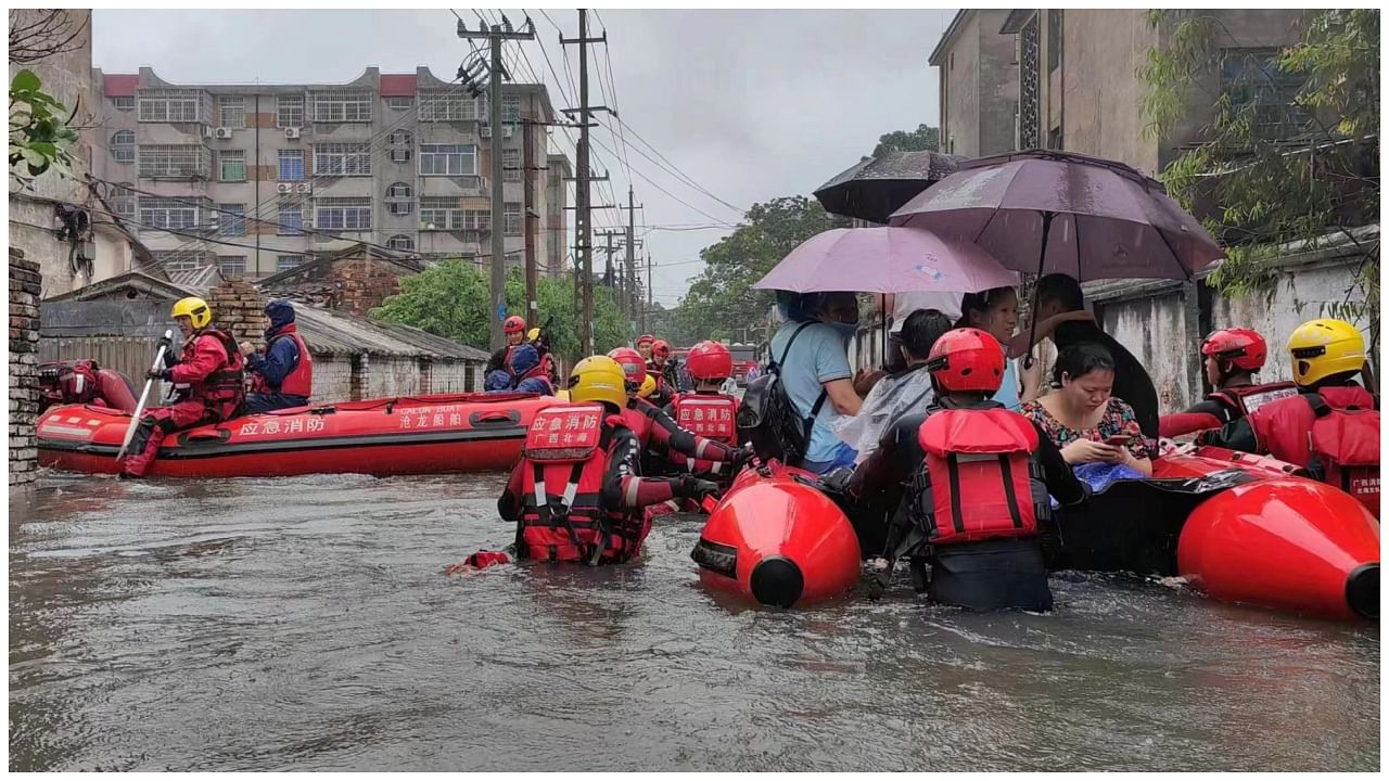 Rescue workers evacuate stranded residents on a flooded street following heavy rainfall in Beihai, Guangxi Zhuang Autonomous Region, China June 8, 2023. Credit: Reuters Photo