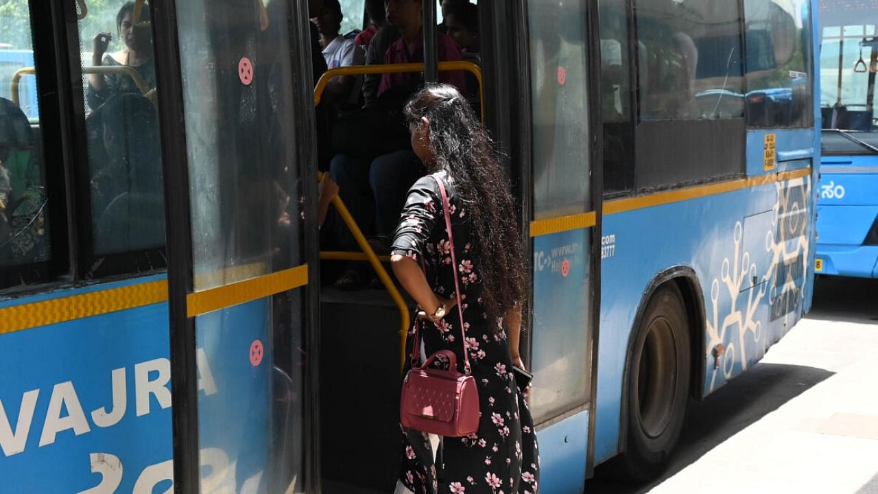 A woman boarding at a BMTC bus the day before launch of ‘Shakthi scheme’ (women free boarding on BMTC and KSRTC buses) at Majestic in Bengaluru 