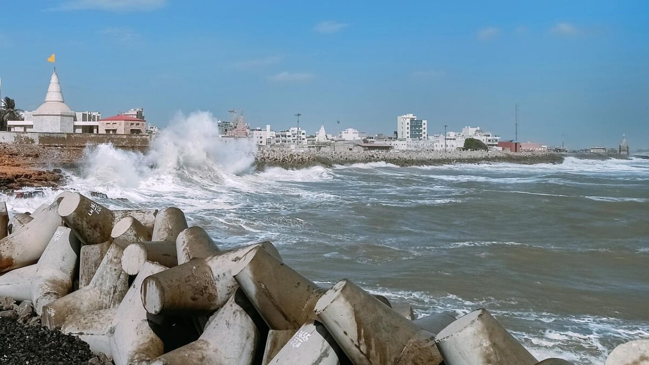 Waves crash against the jetty at a fishing harbour ahead of the expected landfall of Cyclone Biparjoy, in Dwarka district. Credit: PTI Photo