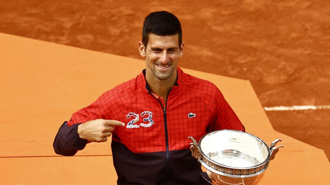 Novak Djokovic poses with the trophy after winning the French Open and his 23rd Grand Slam. credit: Reuters Photo