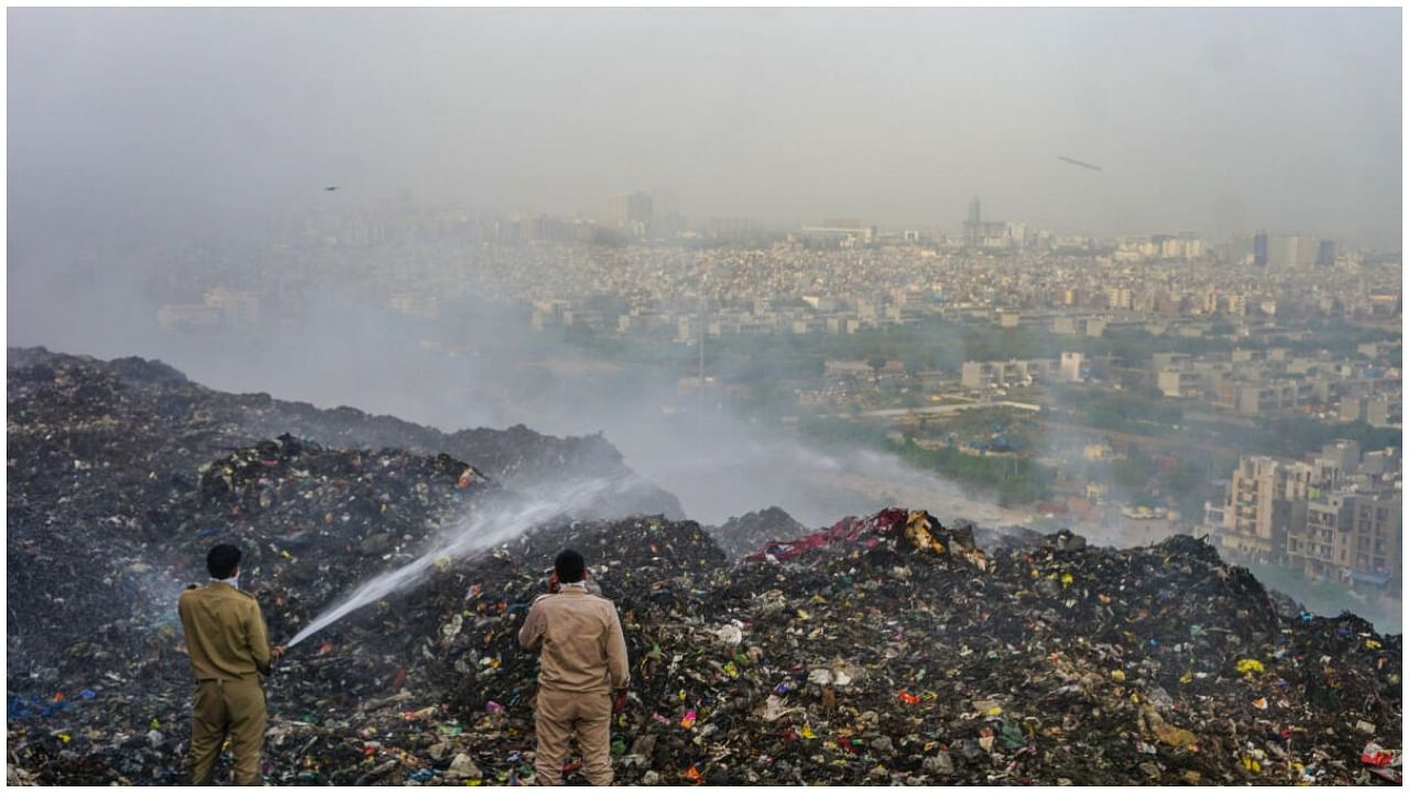 Firemen douse a fire that broke out at the Ghazipur landfill site in, in New Delhi, Monday, June 12, 2023. Credit: PTI Photo