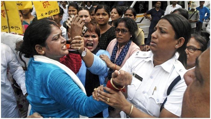 Police personnel detain Congress supporters during a protest in front of West Bengal State Election Commission office against the alleged killing of their party's worker in Murshidabad district ahead of Panchayat polls, in Kolkata, Saturday, June 10. Credit: IANS Photo