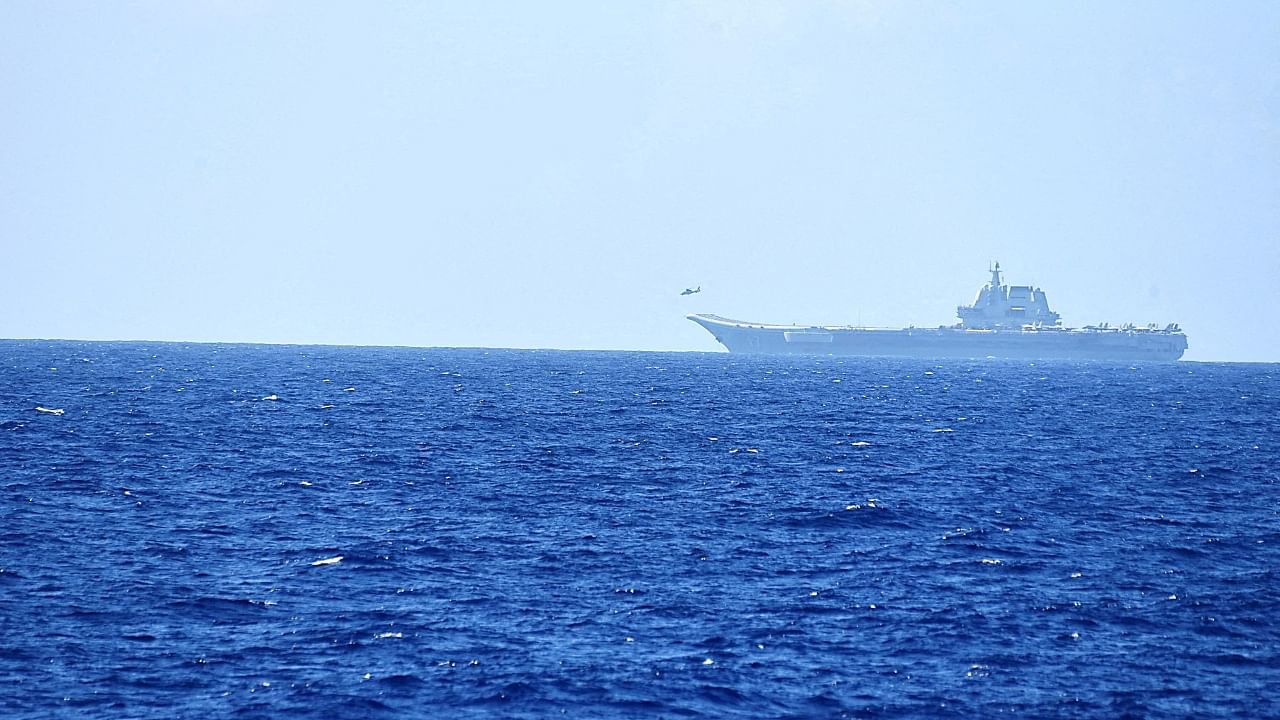 A helicopter takes off from China's Shandong aircraft carrier, over Pacific Ocean waters, south of Okinawa prefecture, Japan, in this handout photo taken April 15, 2023. Credit: Handout via Reuters Photo