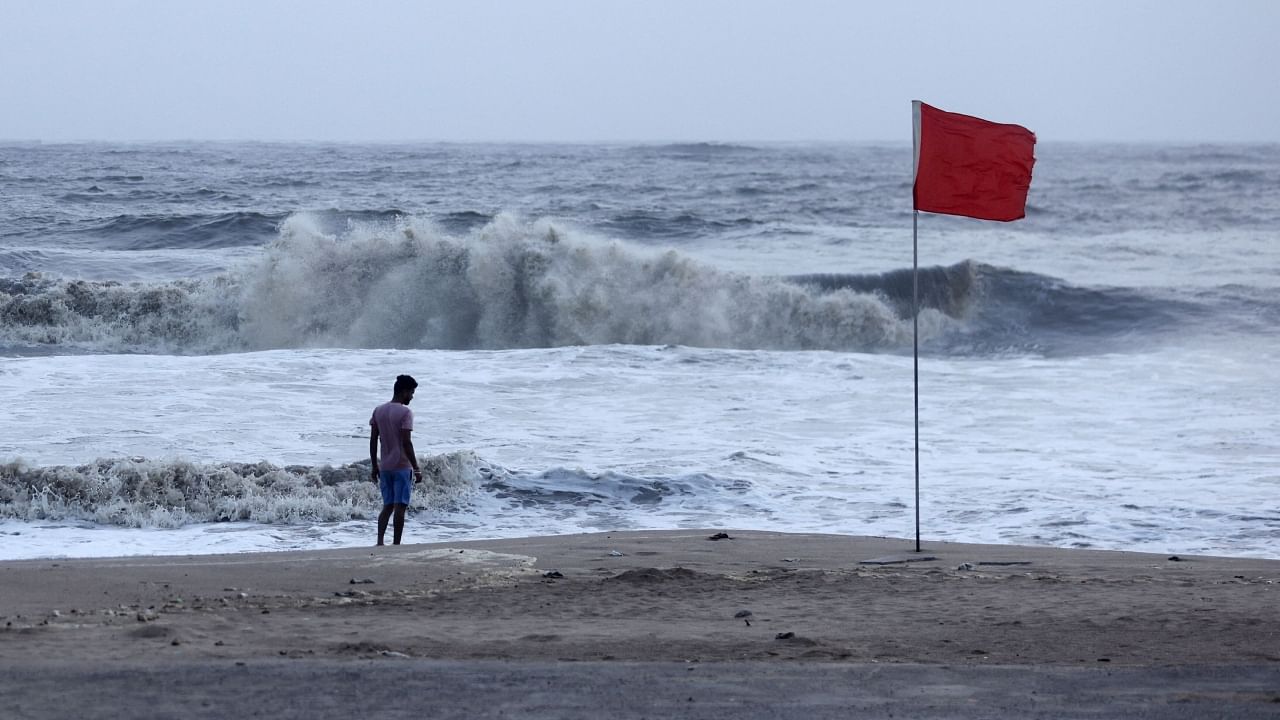 A lifeguard patrols Juhu beach during a red flag alert due to rough seas caused by Cyclone Biparjoy, in Mumbai. Credit: PTI File Photo