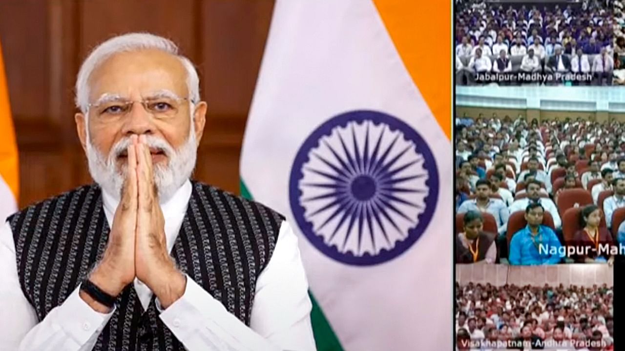  Prime Minister Narendra Modi greets during the distribution of about 70,000 appointment letters to newly inducted recruits via video conferencing. Credit: PTI Photo