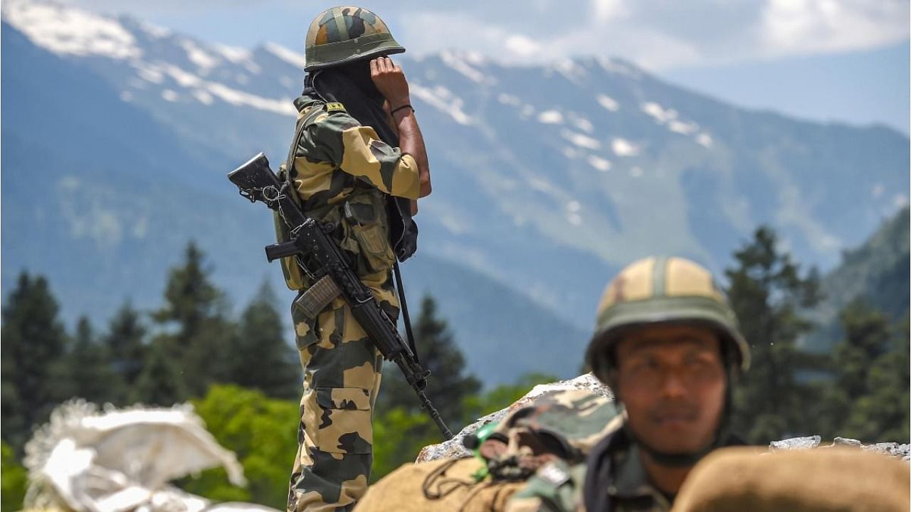 Border Security Force (BSF) personnel stand guard along the Srinagar-Leh National highway, in Ganderbal district of Central Kashmir, Wednesday, June 17, 2020. Credit: PTI Photo