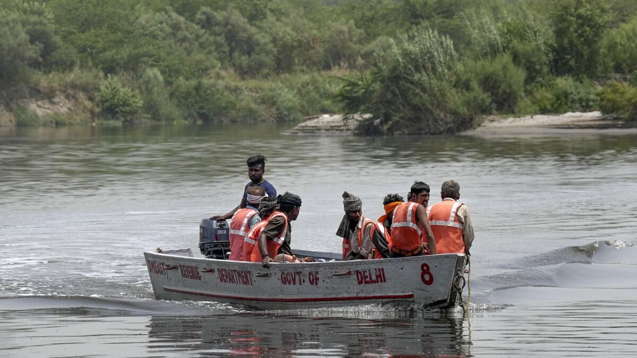 Workers clean the River Yamuna, in New Delhi, Monday, June 12, 2023. Credit: PTI Photo