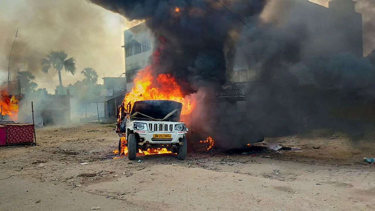 View of a car set ablaze during a clash between supporters of Indian Secular Front (ISF) and Trinamool Congress (TMC) in Bhangore area ahead of the upcoming Panchayat poll. Credit: PTI Photo