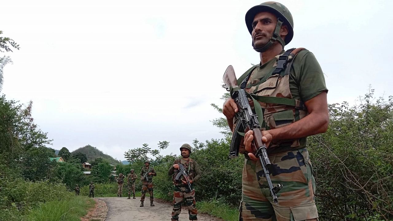 Army officials patrol in the violence-hit area, at Sanasabi in Imphal east district of Manipur. Credit: IANS Photo