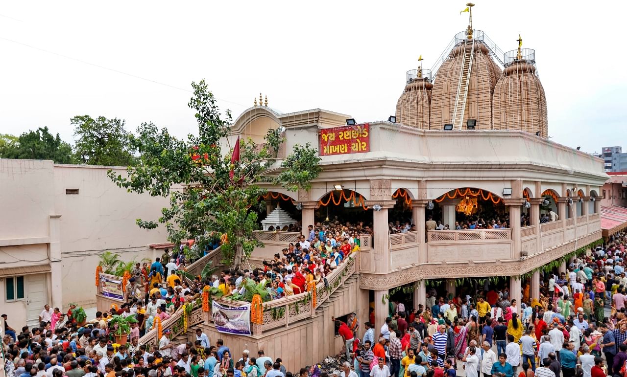 Devotees wait in a queue to take part in a 'bhandara' ahead of the annual Rath Yatra, at Lord Jagannath temple in Ahmedabad, Sunday, June 18, 2023. Credit: PTI Photo
