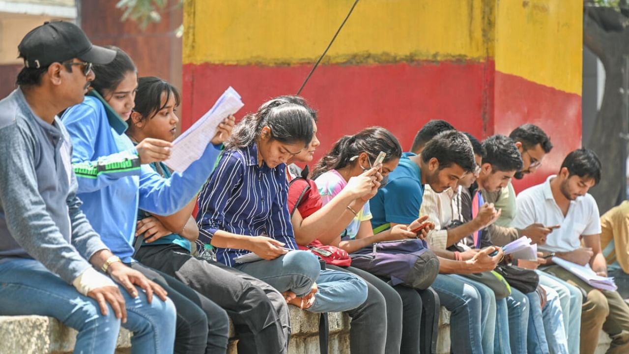 Job aspirants study before entering the exam hall to write public service exams in Bengaluru this year. Credit: DH Photo/ S K Dinesh