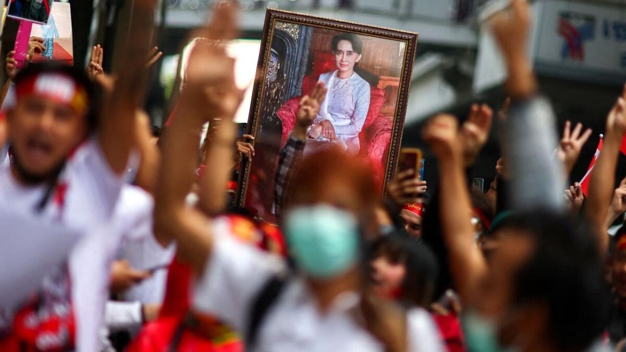 Protesters hold up a portrait of Aung San Suu Kyi and raise three-finger salutes, during a demonstration to mark the second anniversary of Myanmar's 2021 military coup, outside the Embassy of Myanmar in Bangkok. Credit: Reuters Photo