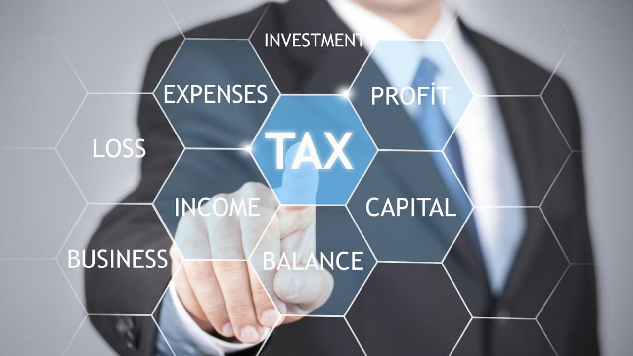 Businessman hand touching tax word on virtual screen the concept of online taxation. Credit: iStock Photo