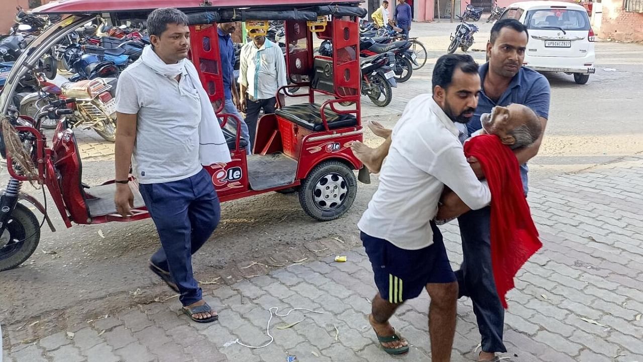 Family members bring their patient at a hospital during heatwave conditions, in Ballia, Sunday, June 18, 2023. Credit: PTI Photo