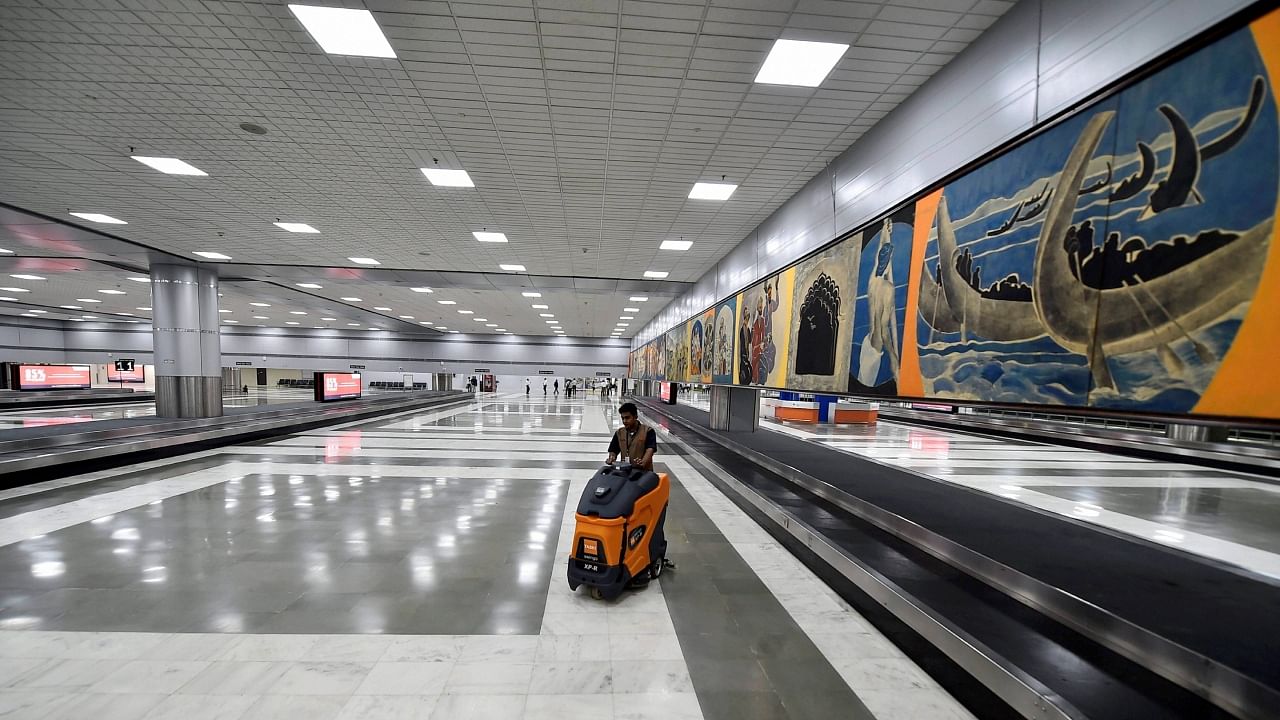  A worker cleans the floor of the revamped Terminal 2 of the Indira Gandhi International Airport in New Delhi. Credit: PTI File Photo