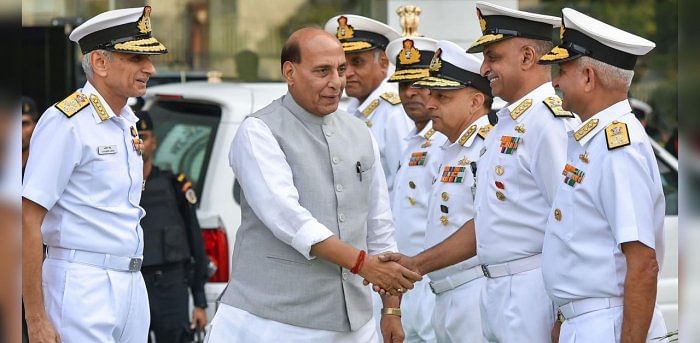 Defence Minister Rajnath Singh with Indian Navy officers. Credit: PTI File Photo