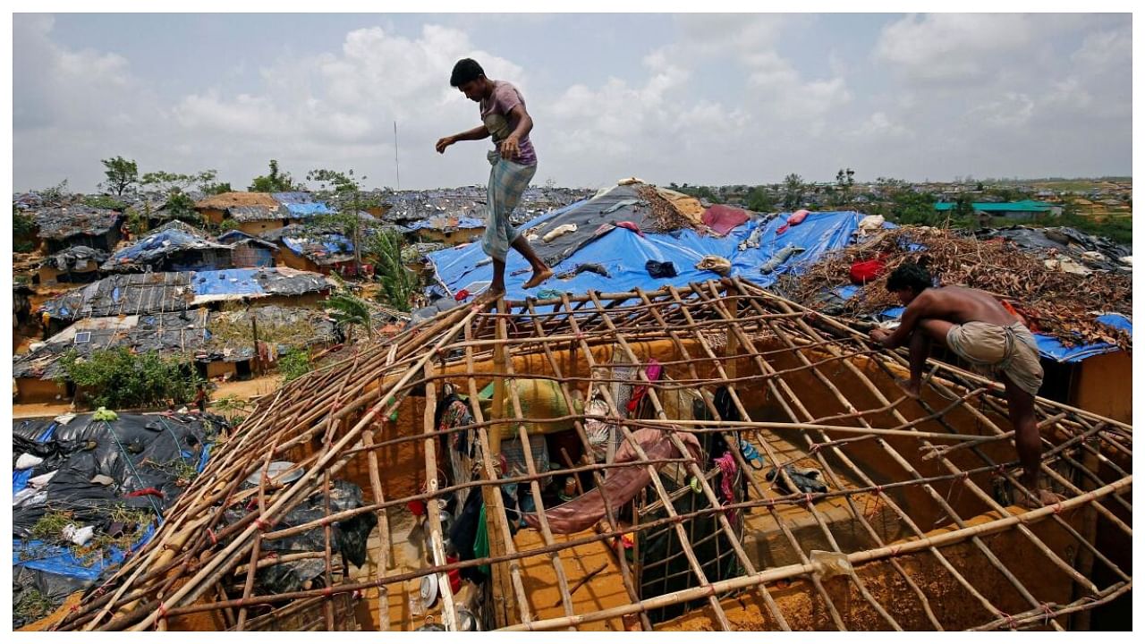 Rohingya refugees rebuild their makeshift house, which was destroyed by Cyclone Mora, at the Kutupalang Makeshift Refugee Camp in Cox's Bazar, Bangladesh June 1, 2017. Credit Reuters File Photo