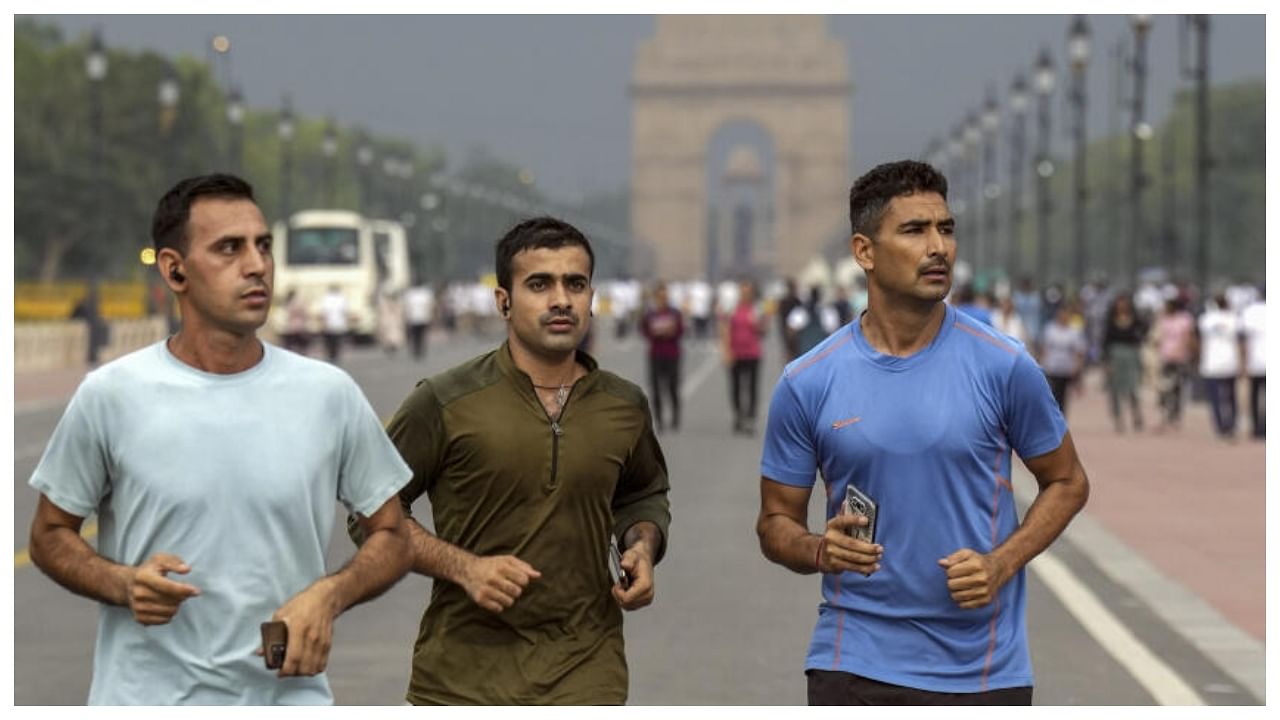 People jog on Kartvya Path near India Gate, in New Delhi, Wednesday, June 21, 2023. Credit: PTI Photo