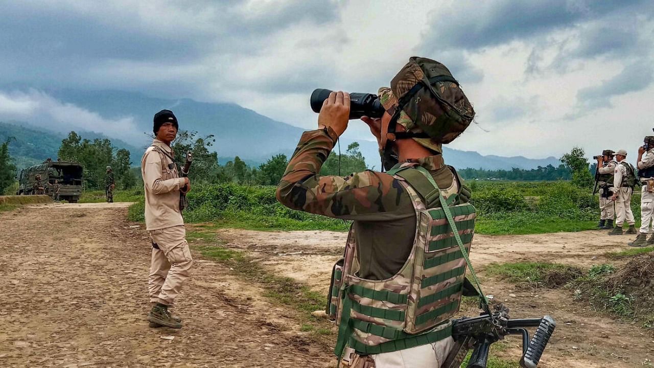 Security personnel patrol at a violence-hit area in Irengbam village of Bishnupur district of Manipur. Credit: PTI Photo