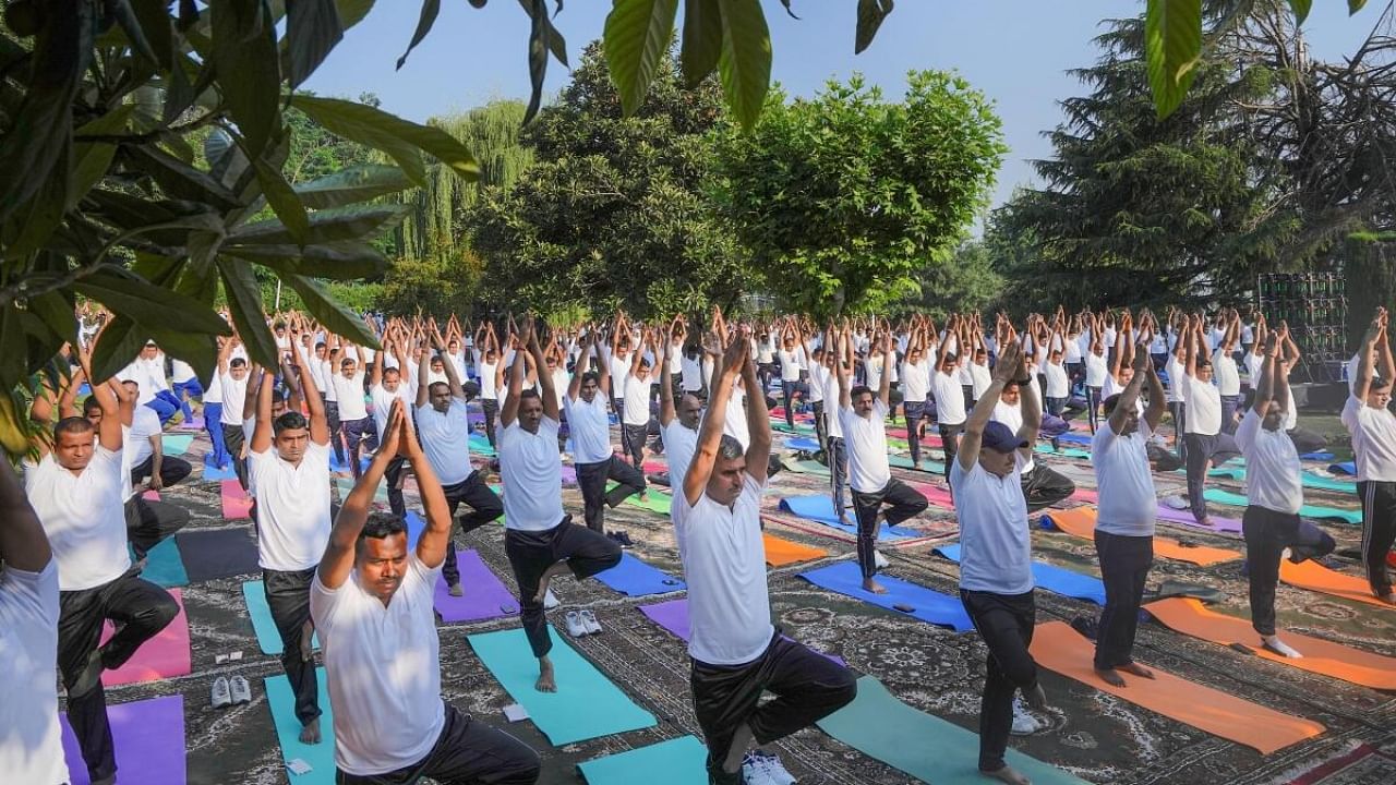 People perform yoga at a session organised on the International Day of Yoga, in Srinagar. Credit: PTI Photo