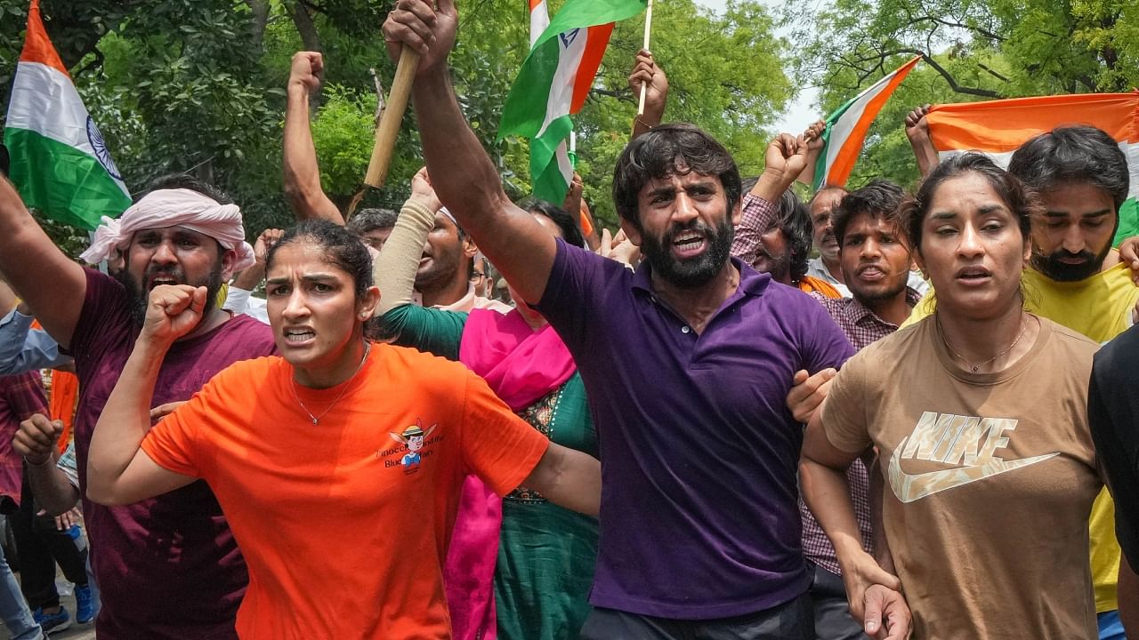 Wrestlers Vinesh Phogat, Sangeeta Phogat and Bajrang Punia with supporters during their protest march towards new Parliament building, in New Delhi, Sunday, May 28, 2023. Credit: PTI File Photo