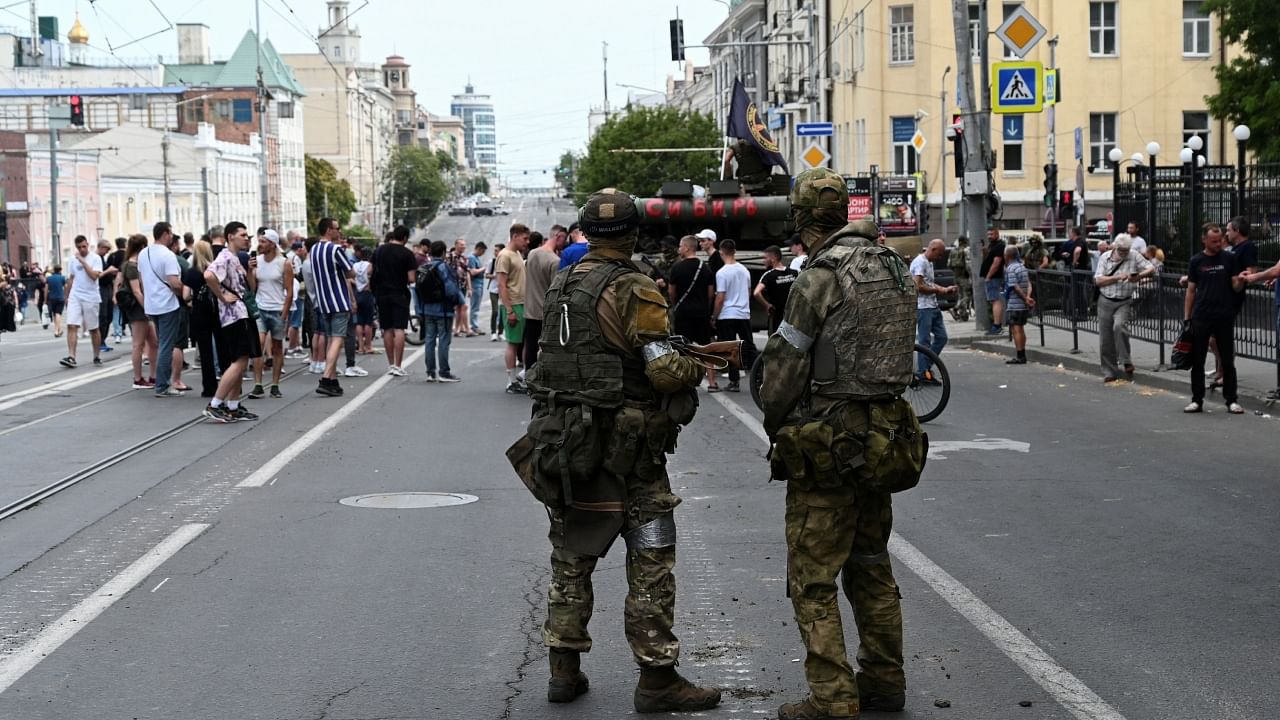 People gather in a street as fighters of Wagner private mercenary group are deployed near the headquarters of the Southern Military District in the city of Rostov-on-Don, Russia, June 24, 2023. Credit: Reuters Photo