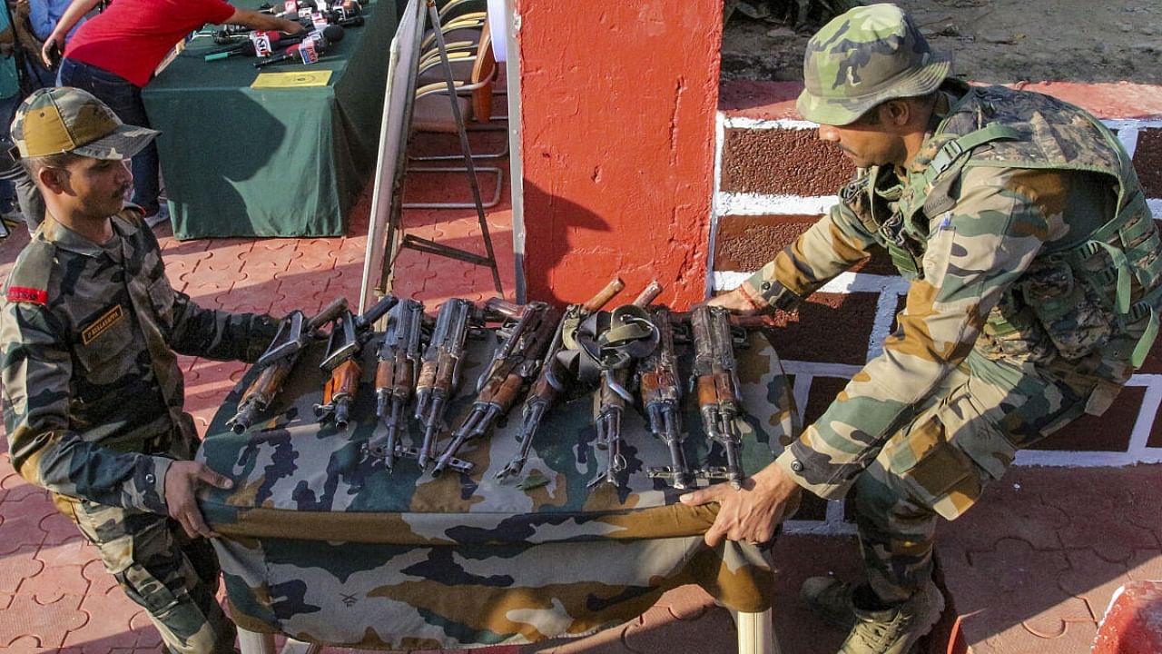 Indian army display arms recovered after foiling an infiltration bid along the Line of Control (LoC) in Jammu and Kashmir’s Machil sector, Kupwara, Friday. Credit: PTI Photo