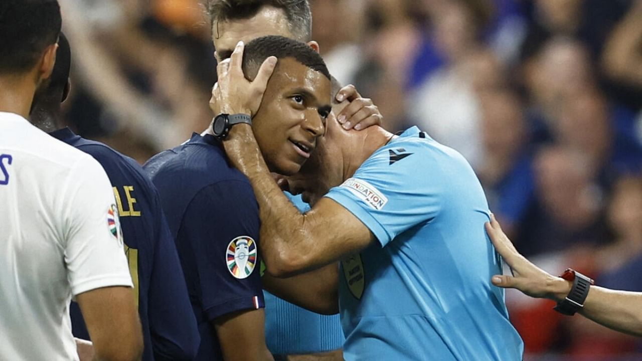 France's Kylian Mbappe with referee Antonio Mateu Lahoz after the match. Credit: Reuters Photo